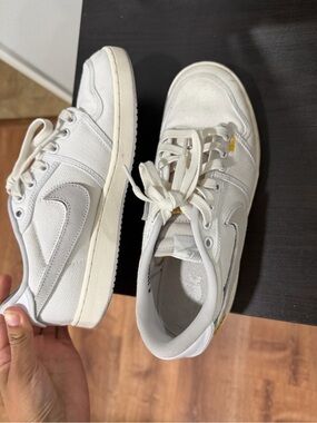Nike White Canvas Sneakers with Light Gray Swoosh and Yellow Accent